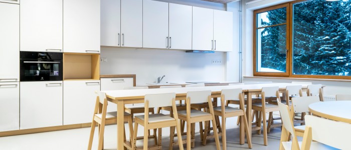 Modern school teaching kitchen with long worktable